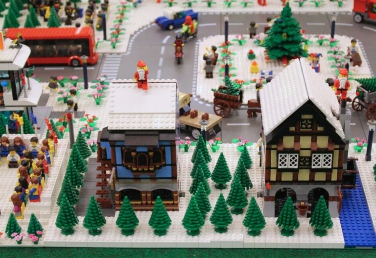 A festive scene made out of LEGO Bricks depicting a busy street with holiday LEGO decorations